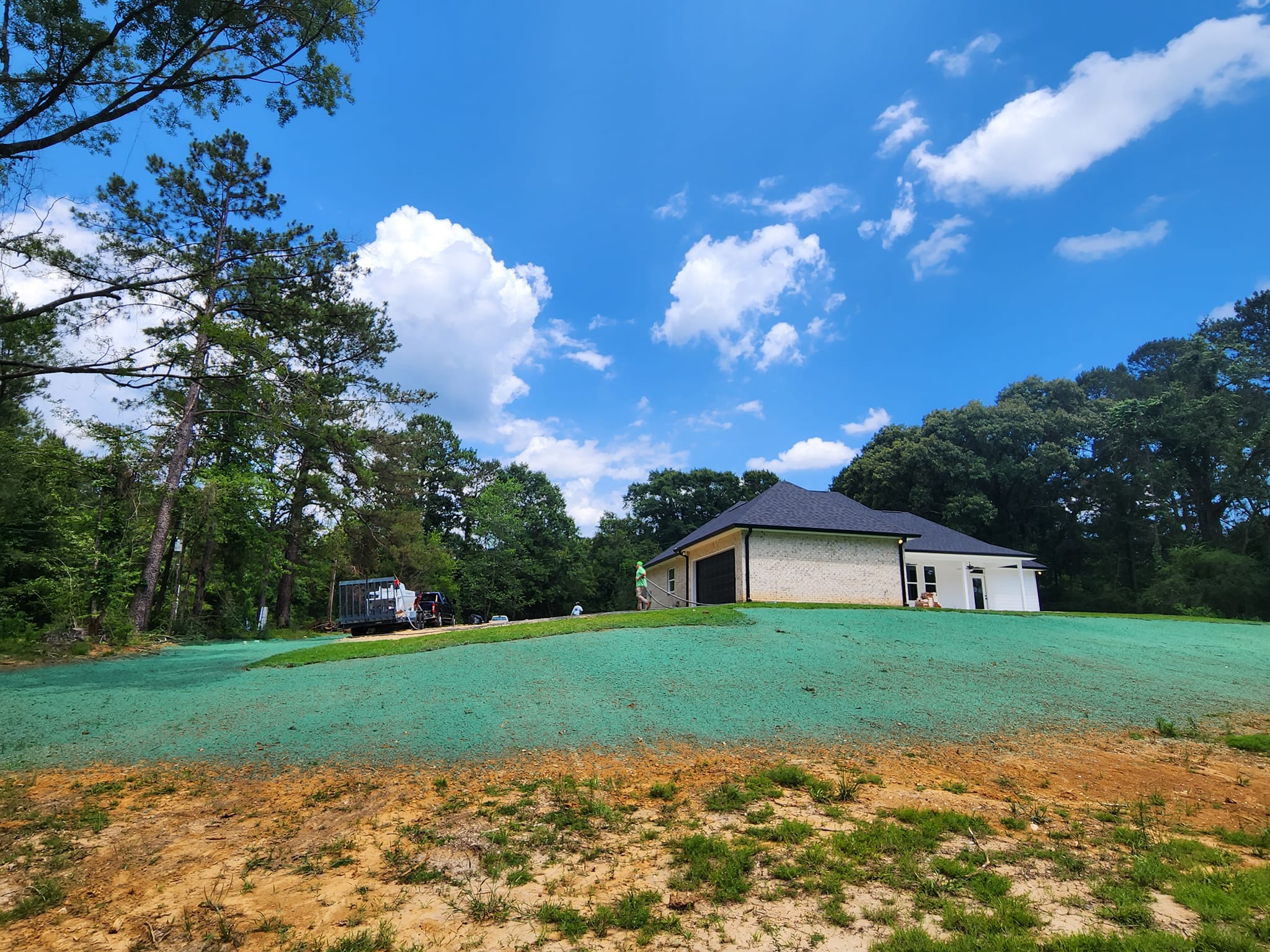 Hydroseeding application across a steep graded property near Covington